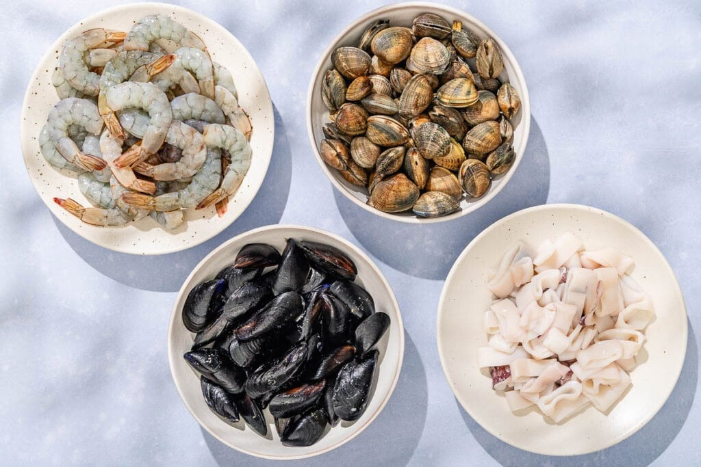 Bowls of shrimp, clams, mussels and calamari for the seafood salad.