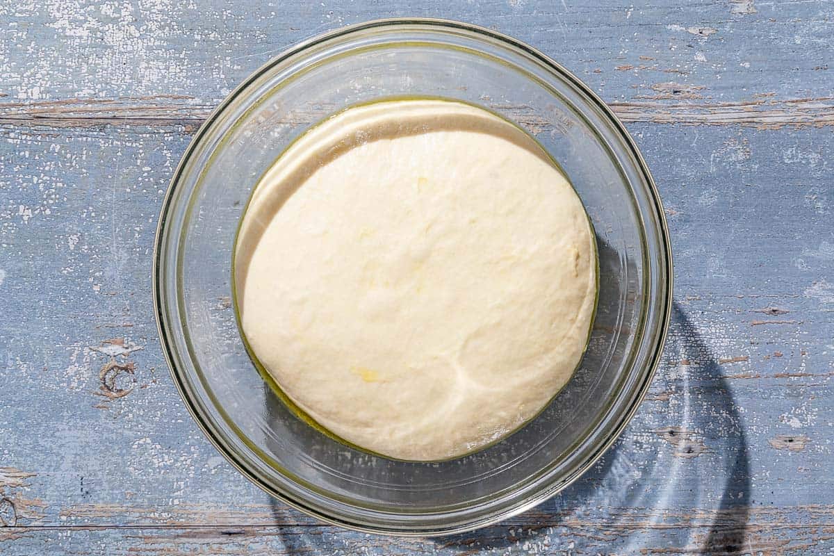 The dough for the pissaladière rising in a bowl.