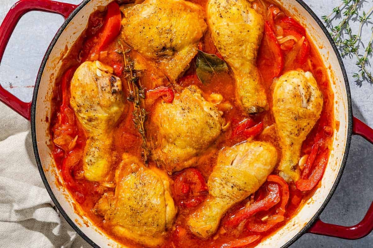Chicken and peppers in a skillet.