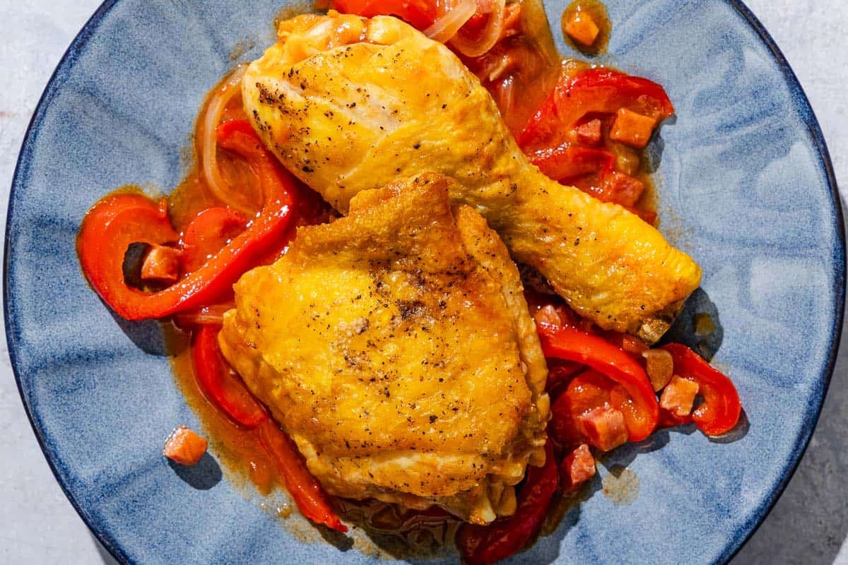 A serving of chicken and peppers on a plate.