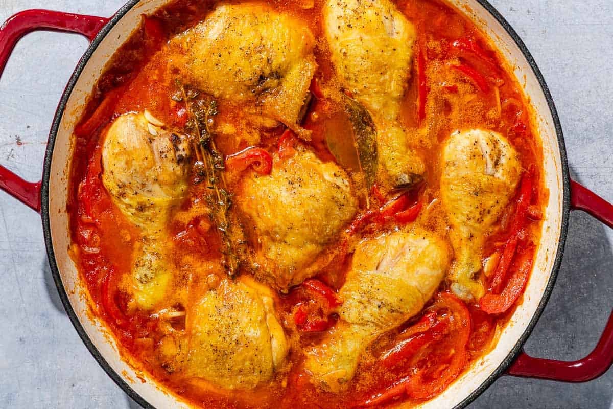 Chicken and peppers in a skillet.