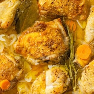 A close up of escabeche de pollo in a skillet.