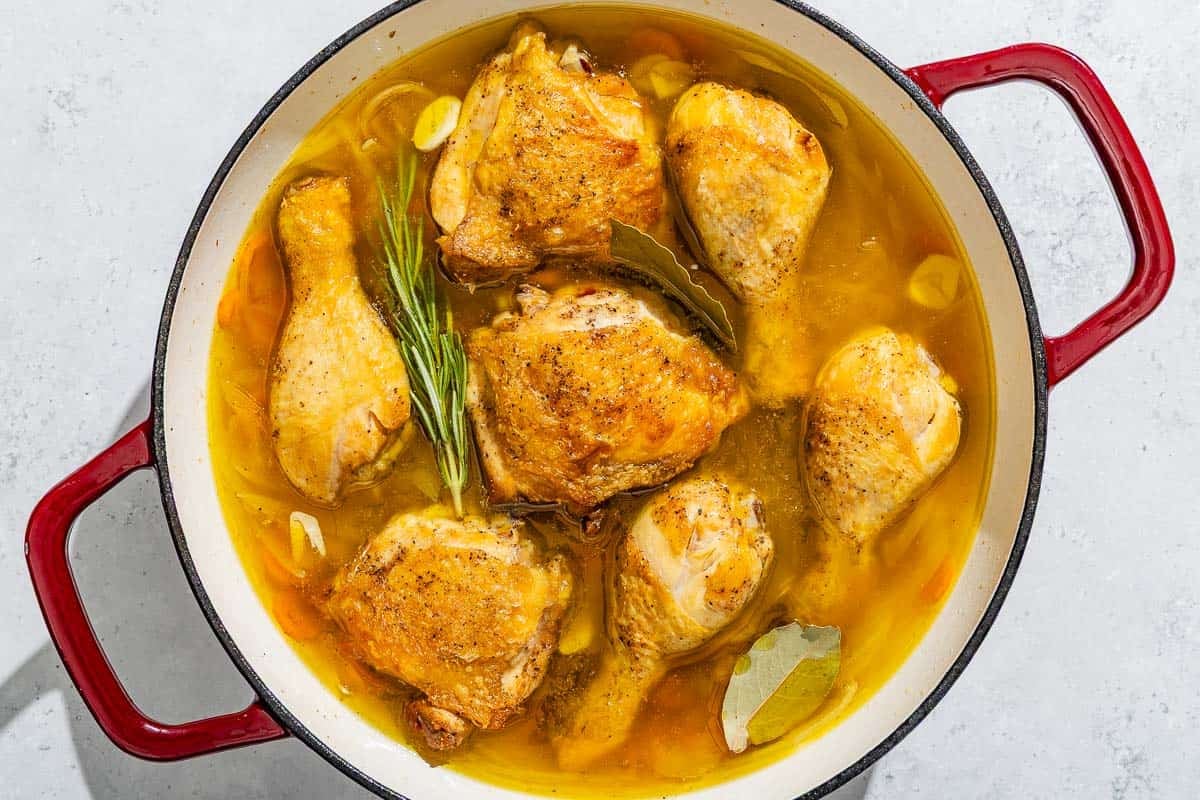 Escabeche de pollo cooking in a skillet.