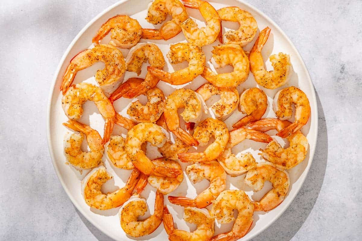 The seasoned shrimp for the shrimp piccata on a platter.