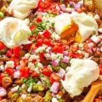 Potato hash with asparagus, chickpeas and feta in a skillet with a wooden spoon.