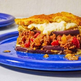 A close up of a serving of moussaka on a plate.