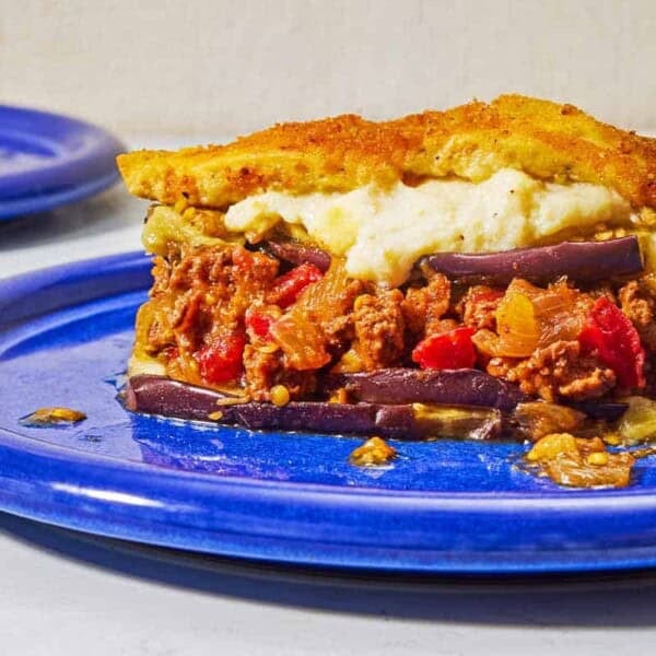 A close up of a serving of moussaka on a plate.