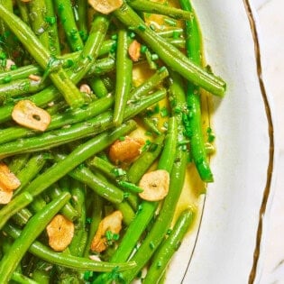 A close up of italian green bean salad in a bowl.