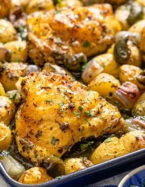 A close up of the baked chicken and potatoes recipe on a sheet pan.