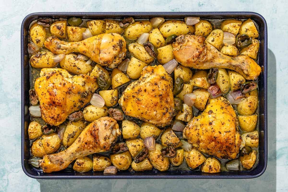 The baked chicken and potatoes recipe on a sheet pan.