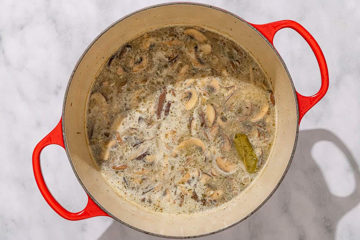 The mushroom soup simmering in a pot.