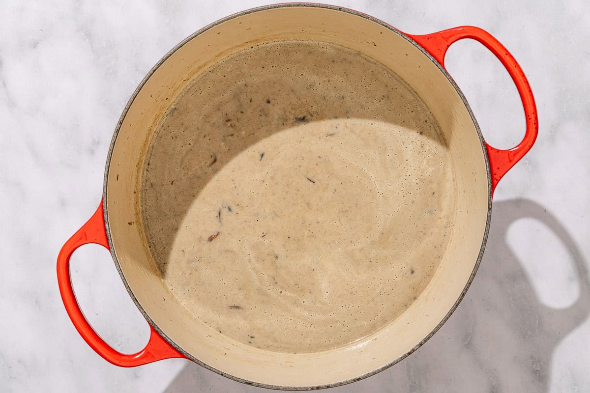 The mushroom soup in a pot after some of is has been blended and added back to the soup.