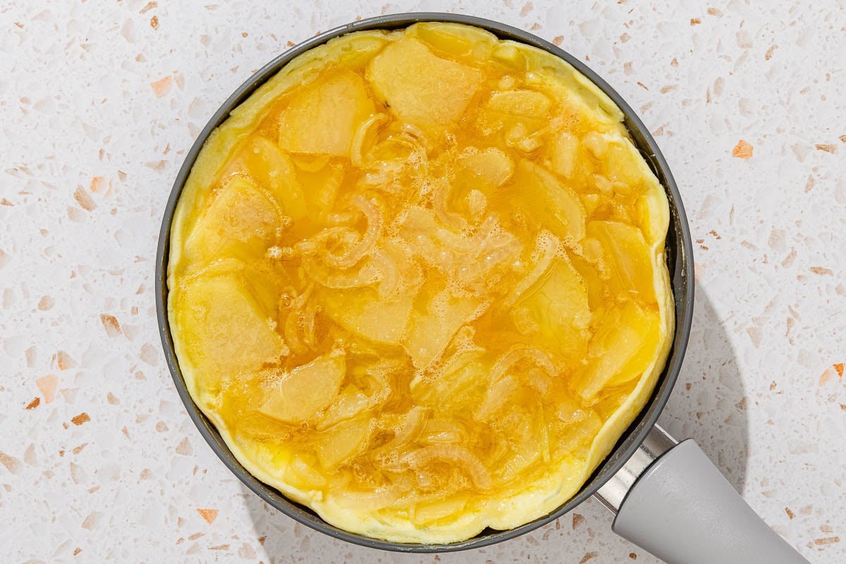 The cooked spanish tortilla in a skillet.