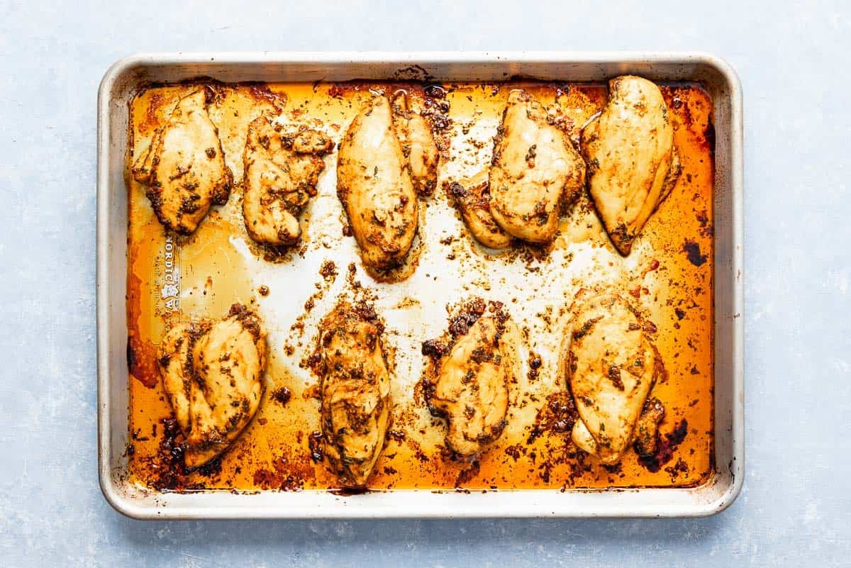 The baked chicken breast for the chicken chermoula on a sheet pan.