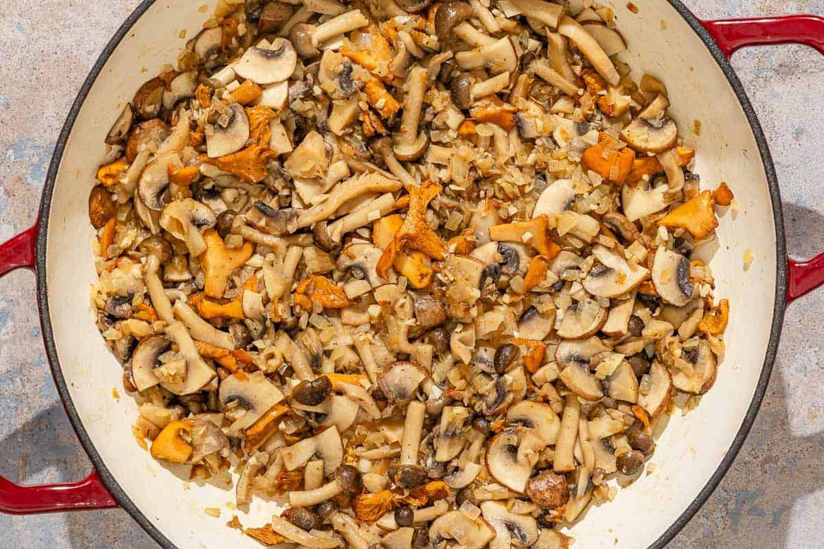 The mushrooms for the mushroom rice being cooked in a skillet.