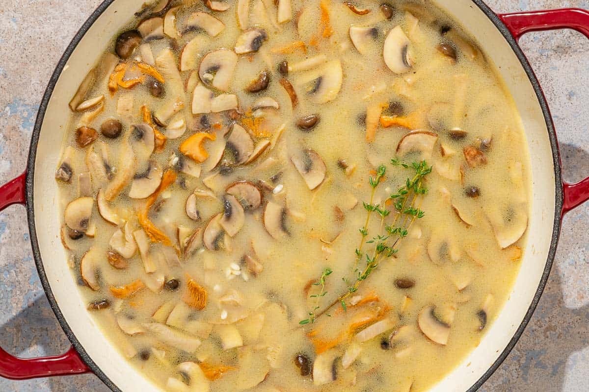 The mushroom rice simmering in a skillet.