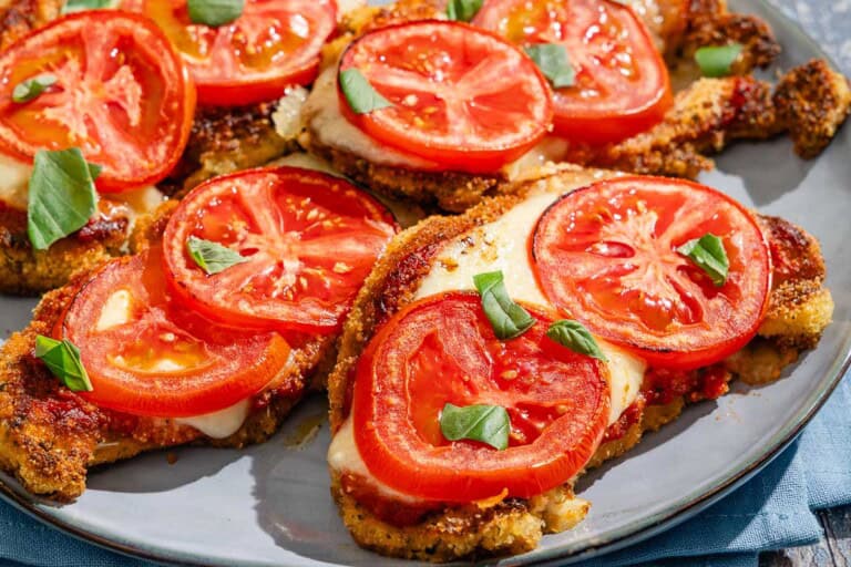 A close up of the pieces of baked cauliflower parmesan on a platter.