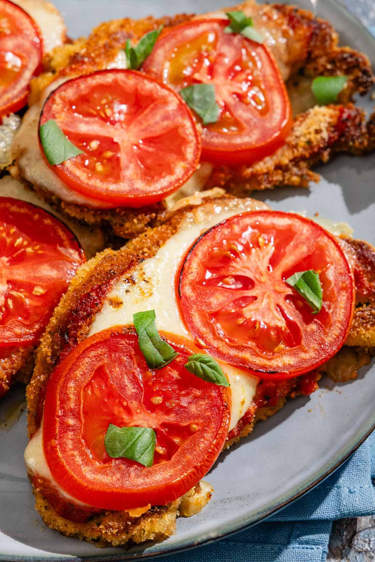 A close up of the pieces of baked cauliflower parmesan on a platter.