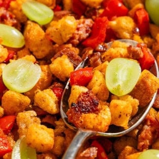 A close up of migas with a spoon.
