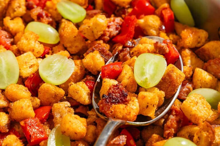 A close up of migas with a spoon.