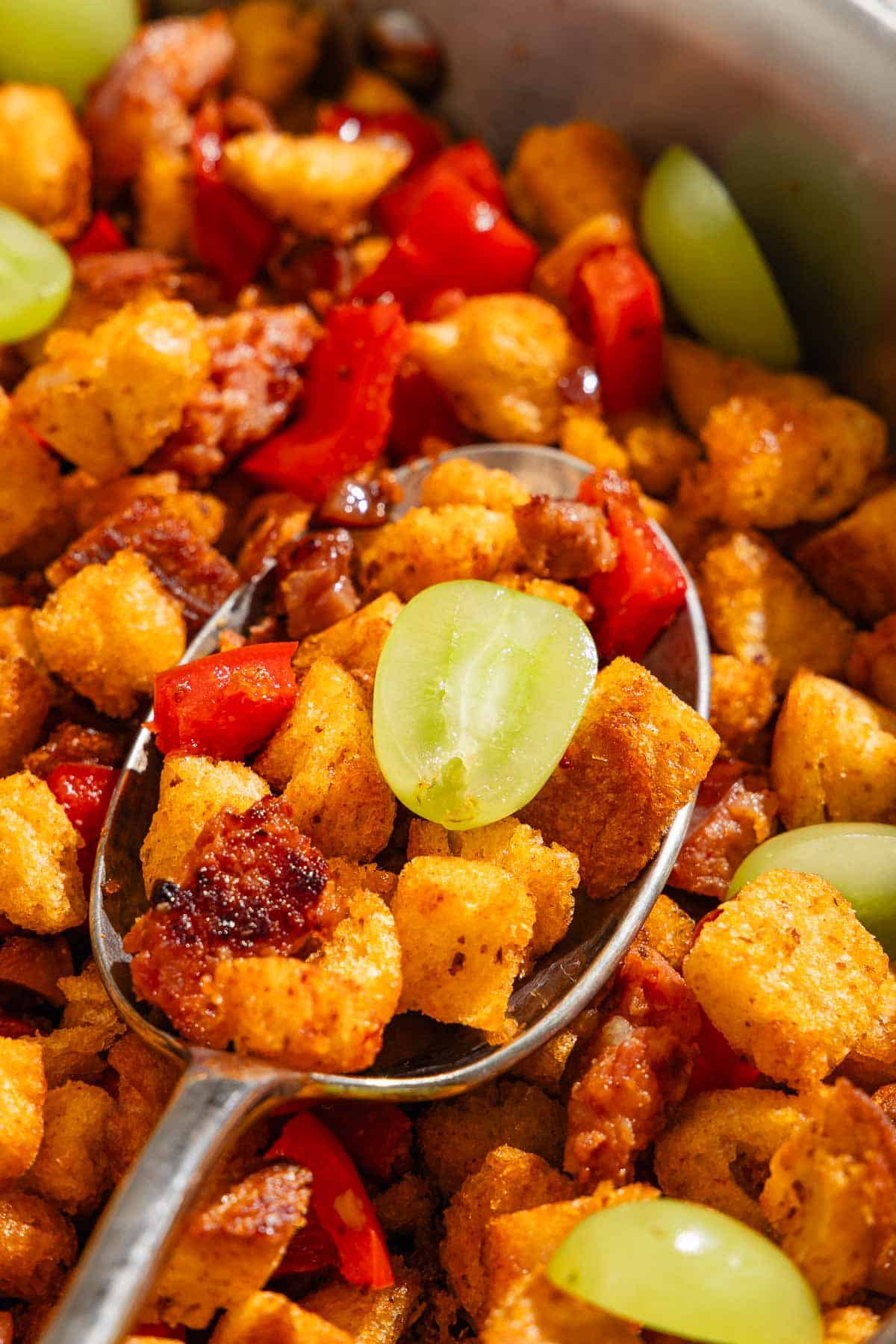 A close up of migas with a spoon.