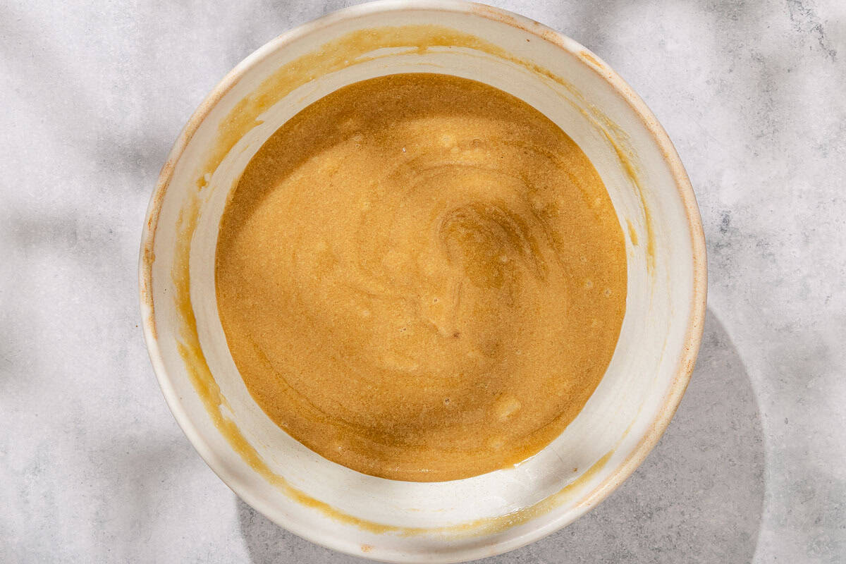 The wet ingredients for the tahini chocolate chips cookies mixed together in a bowl.