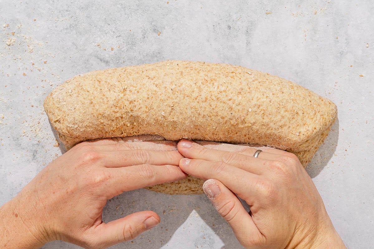 The whole wheat bread dough rolled into a cylinder shape.