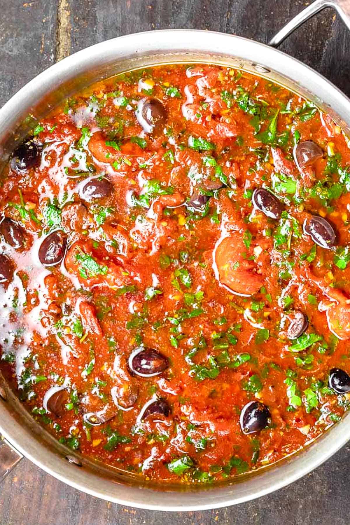 The sauce for the puttanesca recipe in a tall sided skillet.