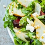A close up of beet and goat cheese salad on a platter. - 7