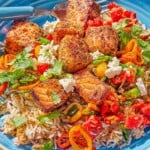 A close up photo of a salmon bowl with a fork.