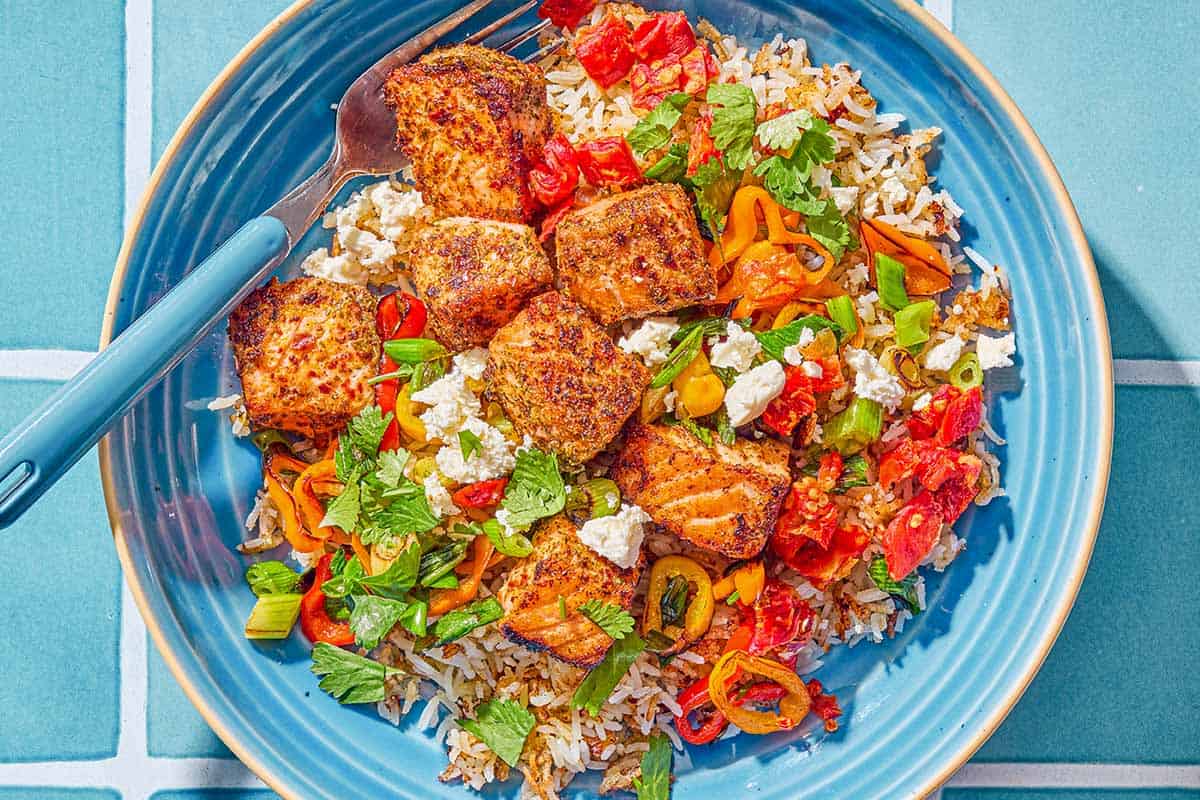 An overhead photo of a salmon bowl with a fork.