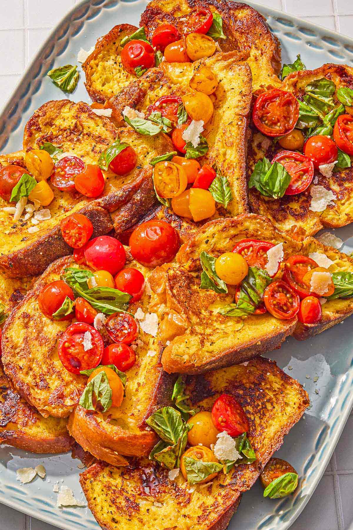 Several slices of savory french toast with the veggie topping on a platter.