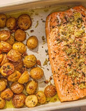 The slow roasted salmon and potatoes in a baking dish.
