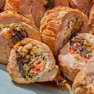 A close up of several slices of the stuffed pork tenderloin.
