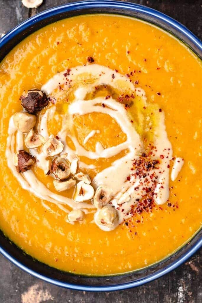 A bowl of roasted butternut squash soup with tahini and honey