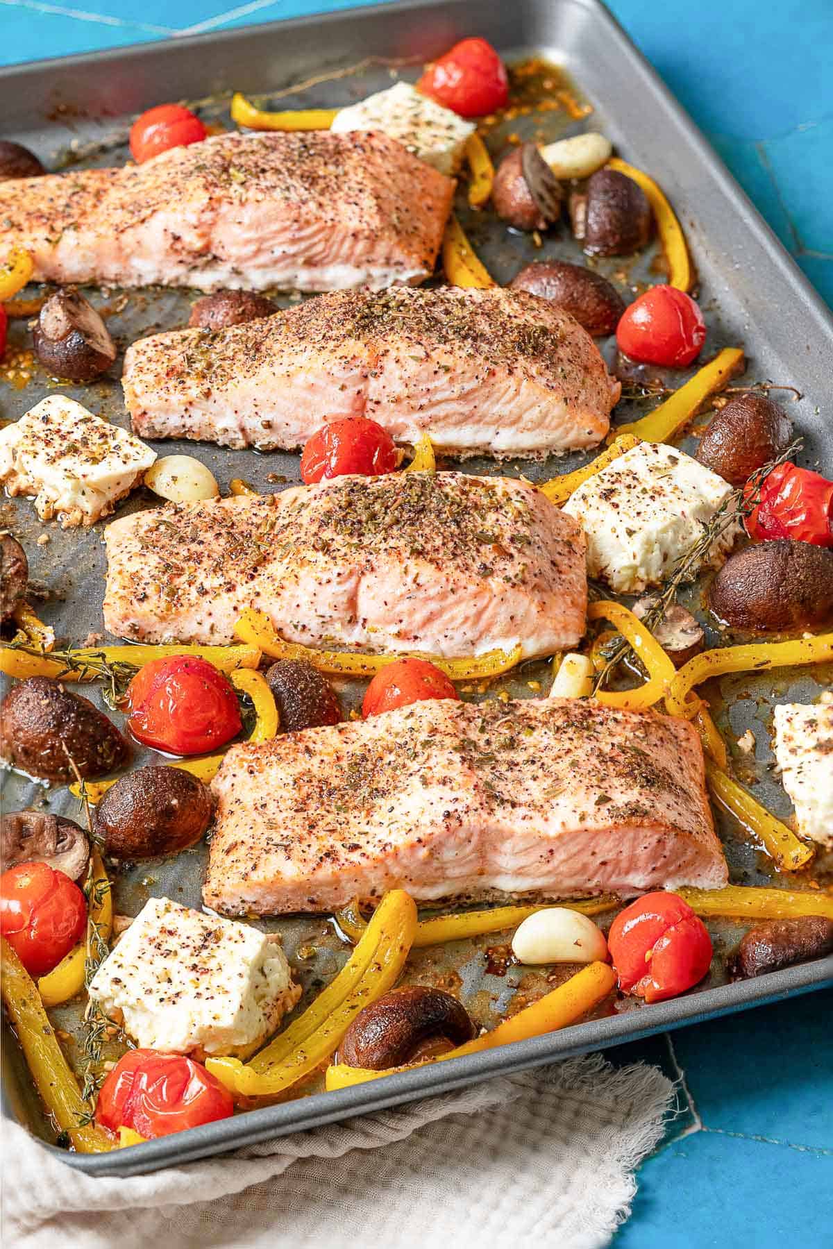 The mediterranean salmon recipe on a sheet pan.