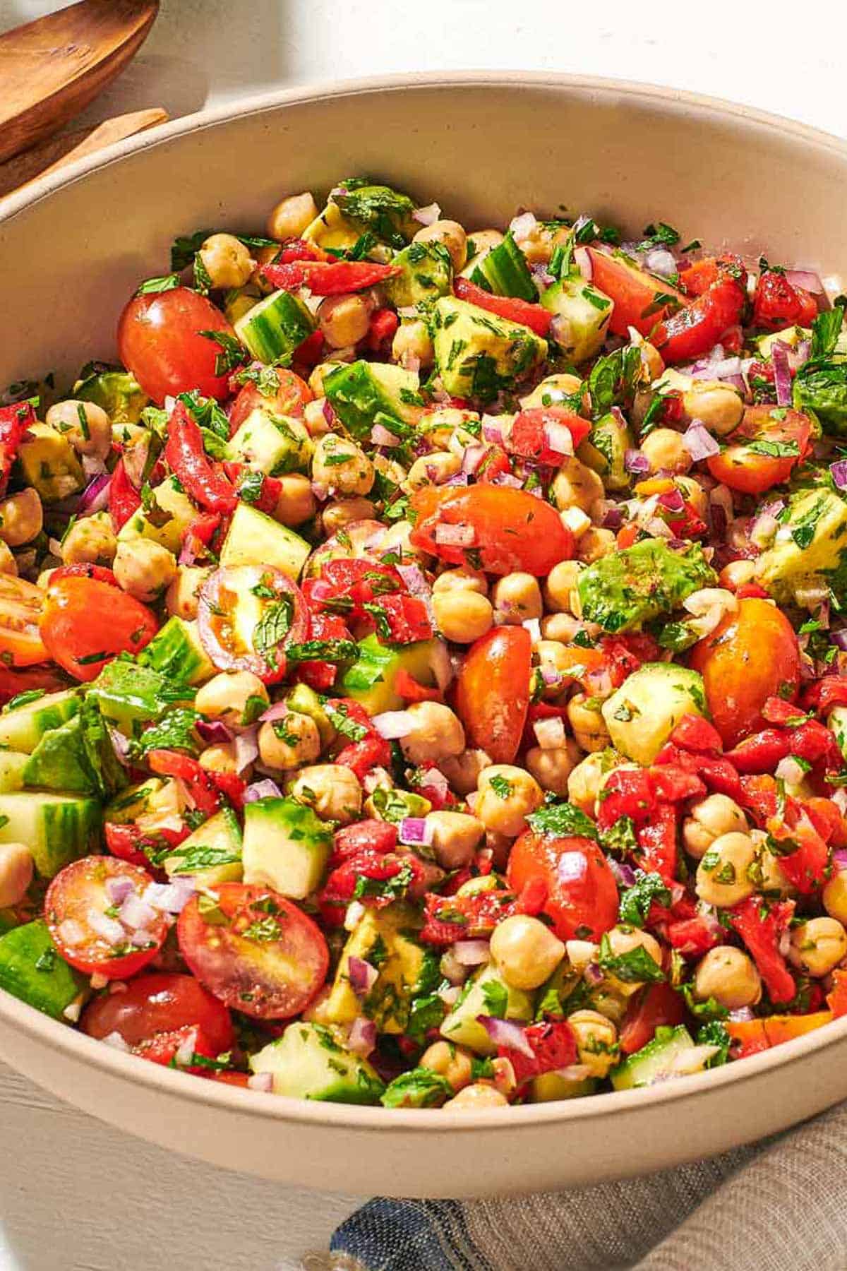 A close up of chickpea salad in a bowl.
