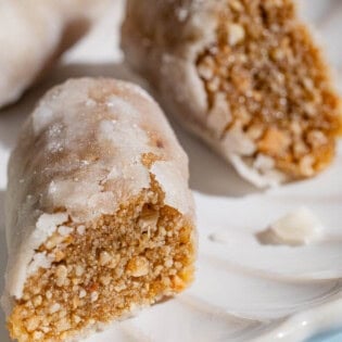 A close up of two alfajores halves on a plate.