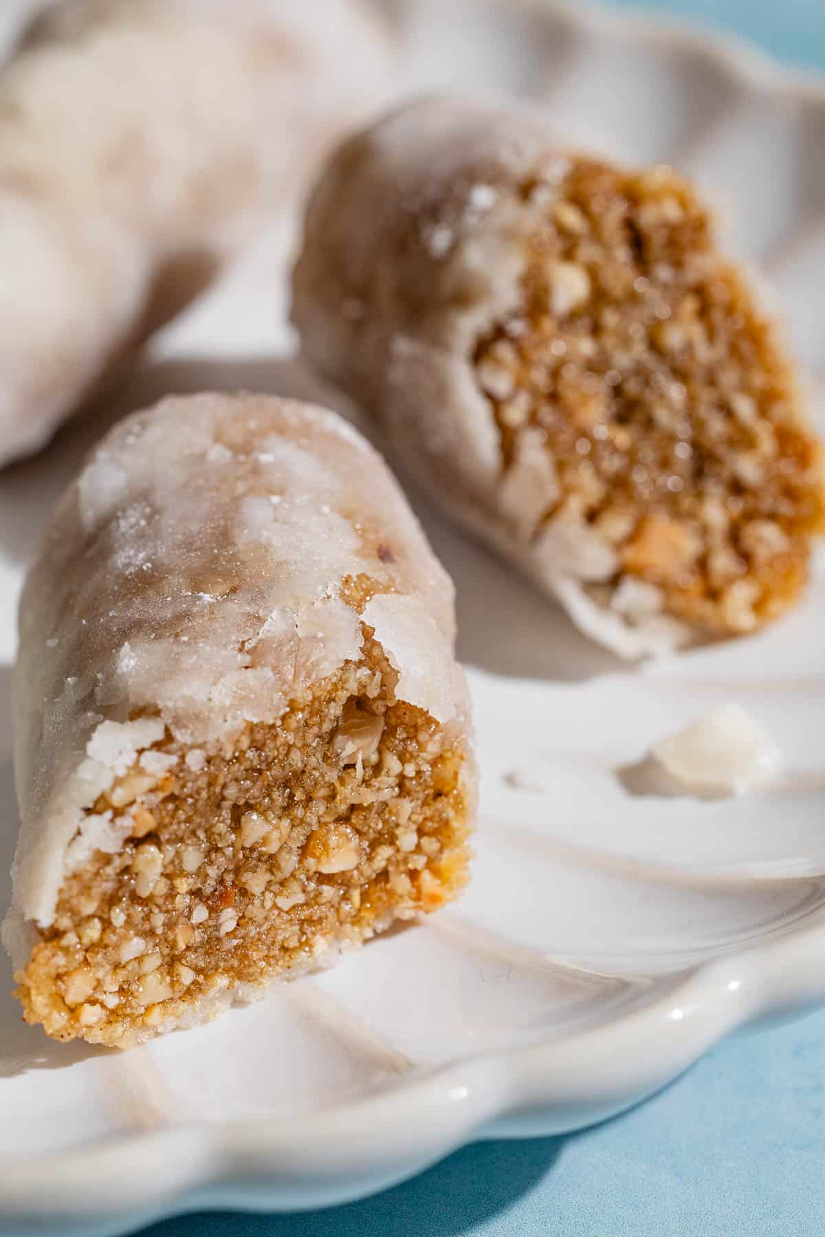 A close up of two alfajores halves on a plate.