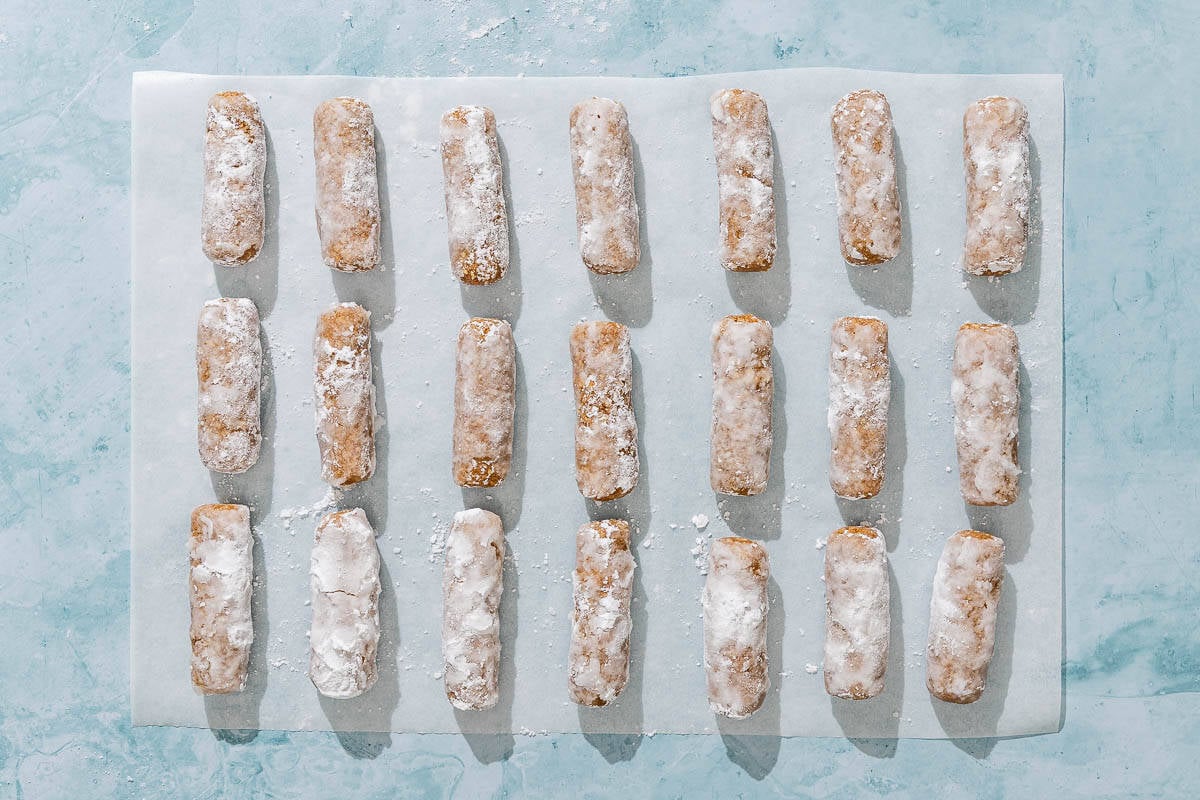 Several alfajores even spread on a piece of parchment paper.