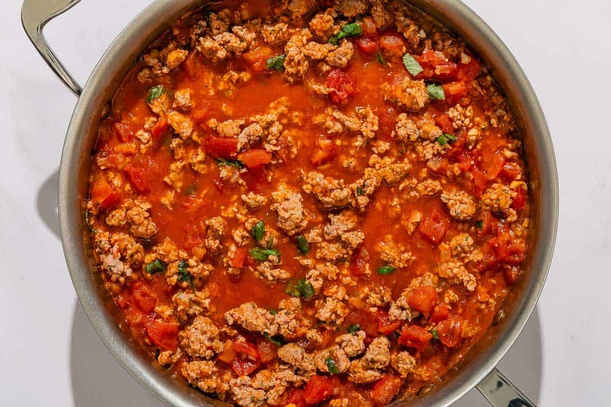 The meat sauce for the baked ziti simmering in a skillet.