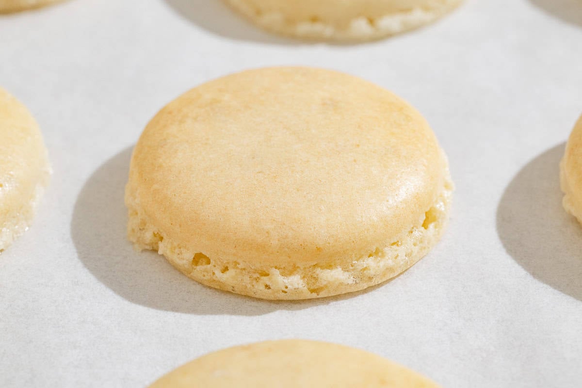 A close up of baked macaron shell.