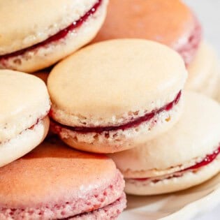 Several macarons stacked on a platter.