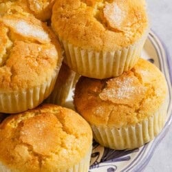 A close up of a stack of magdalenas on a platter.