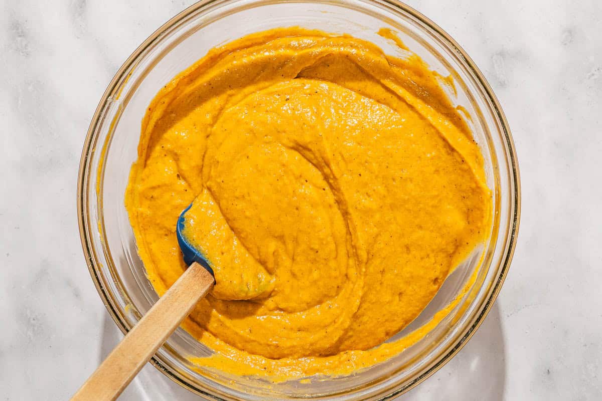 The batter for the pumpkin bread in a bowl with a spatula.
