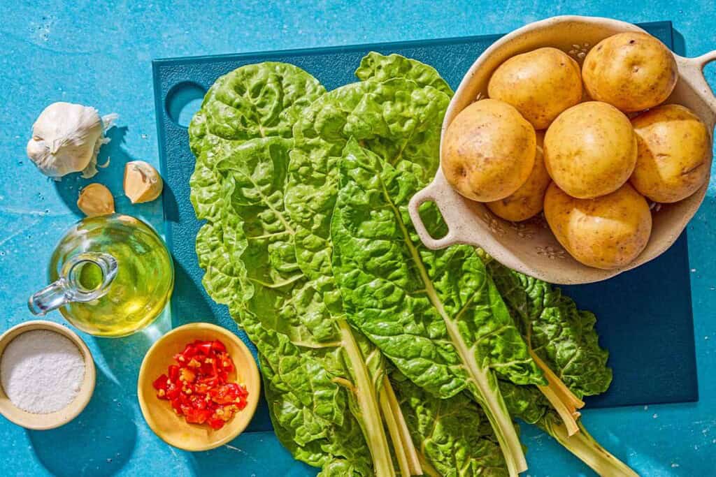 Ingredients for blitva including swiss chard, yukon gold potatoes, salt, olive oil, garlic, and calabrian chilies.