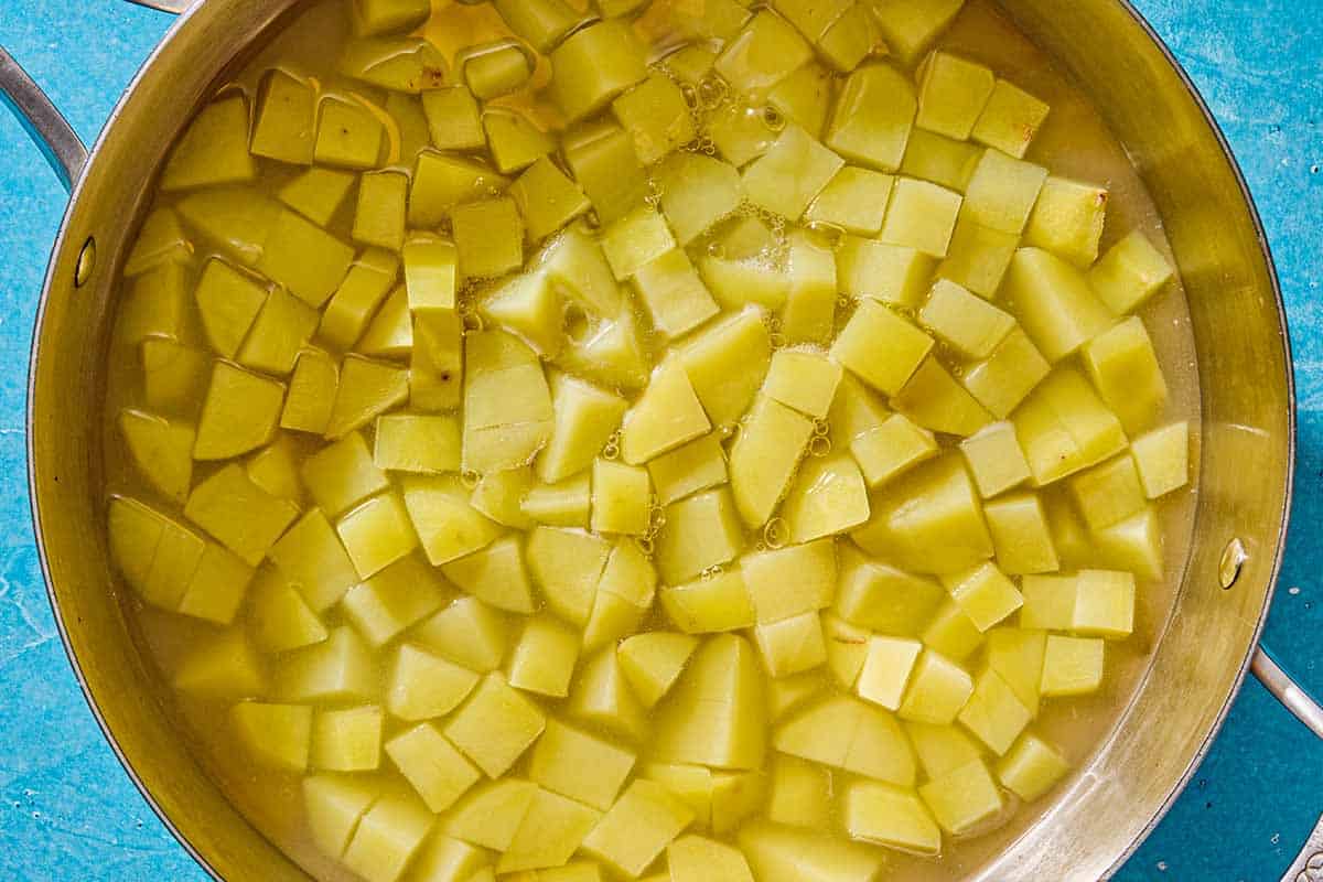 The cubed potatoes for the blitva in a pot of water.