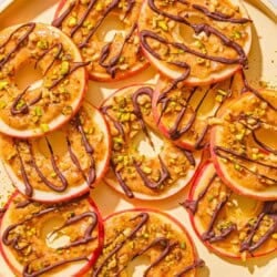 Several caramel apple slices on a platter.