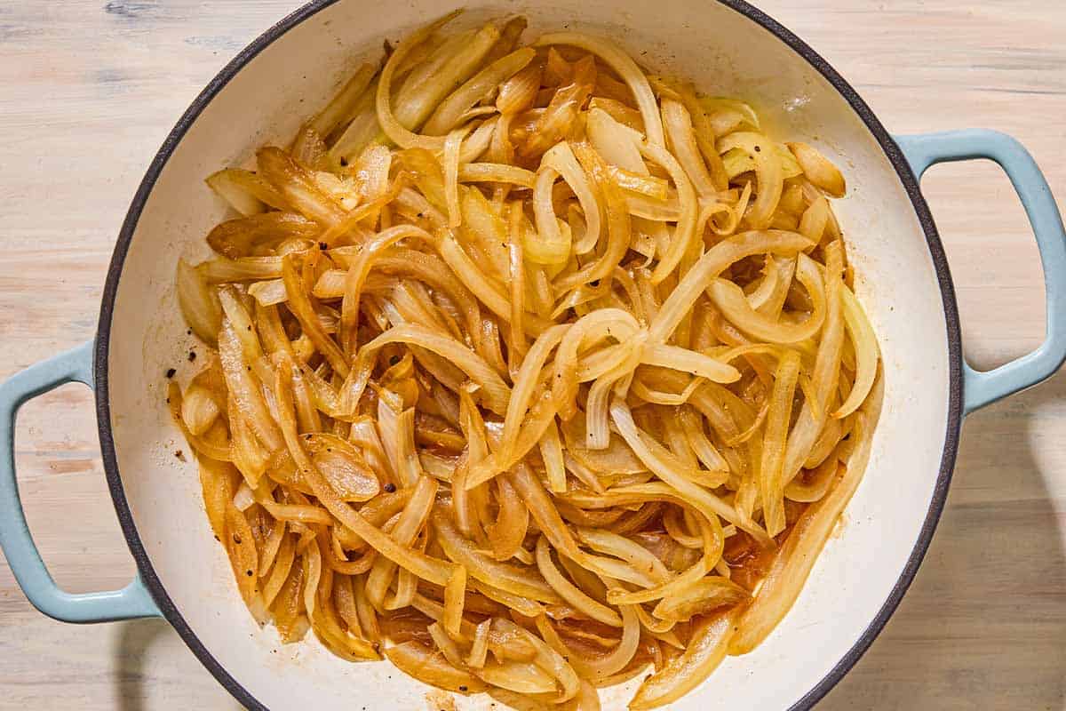 The softened onions for the french onion chicken in a skillet.
