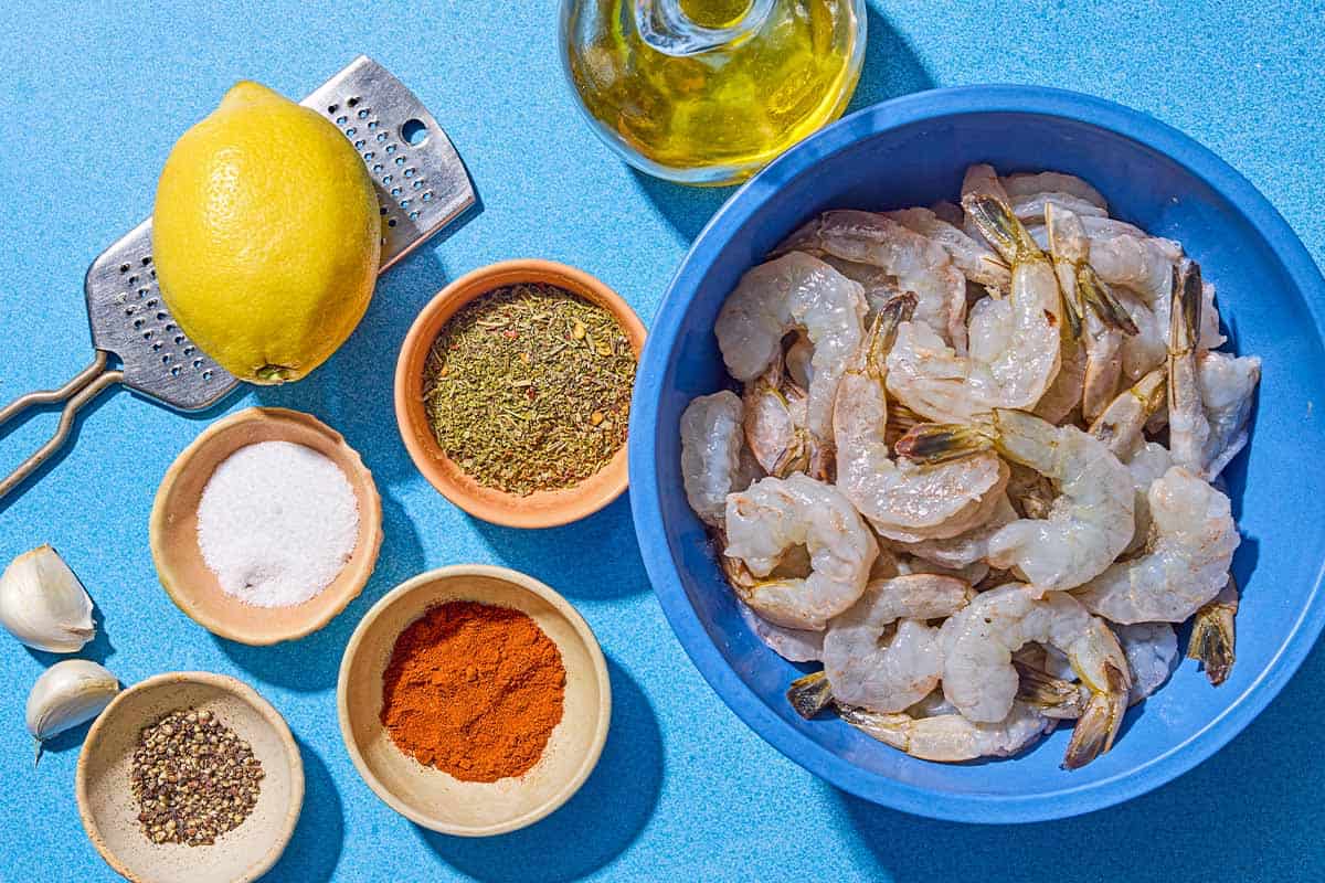 Ingredients for sautéed shrimp including shrimp, lemon, olive oil, garlic, salt, pepper, italian seasoning and paprika.
